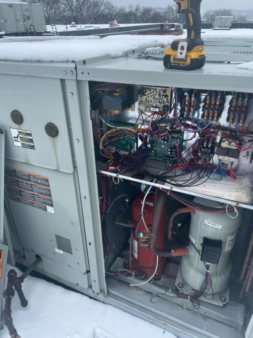 Open commercial HVAC control panel showing wiring and circuit boards during a Chartiers Mechanical service call